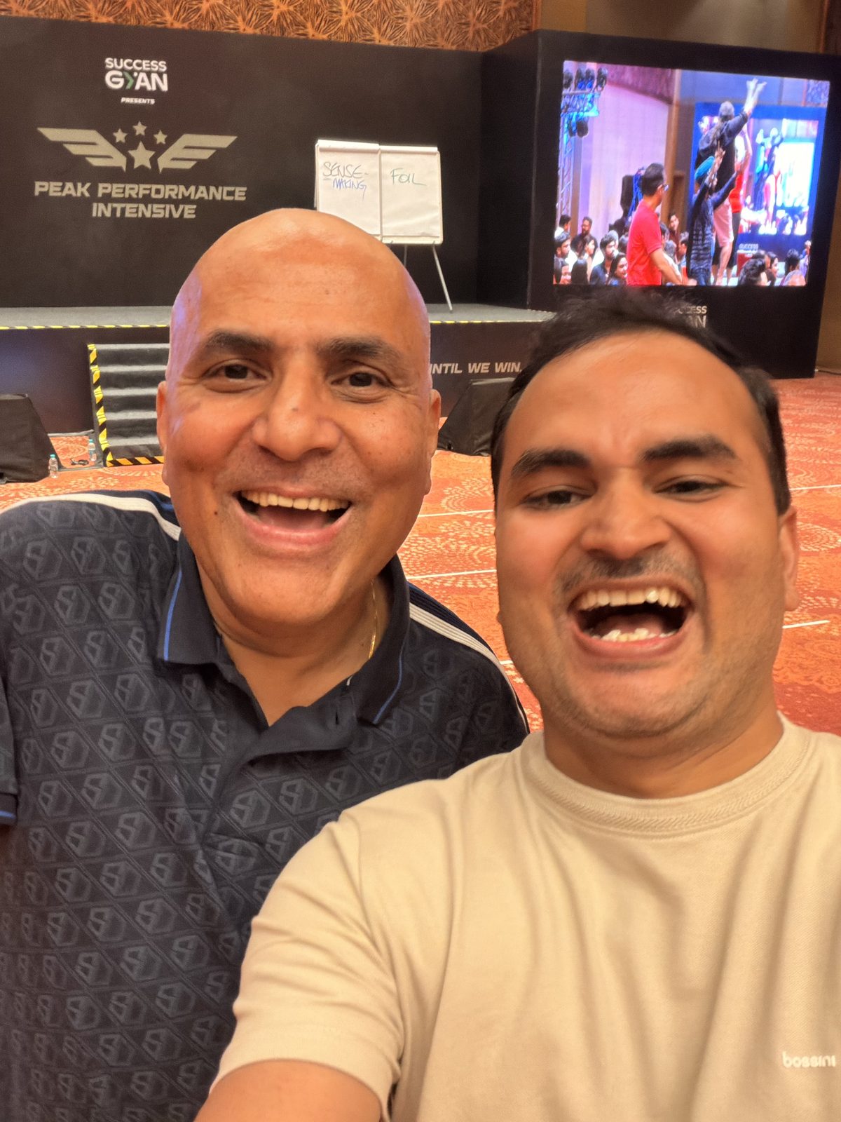 Akshay Mishra with a peer on the floor at the Peak Performance Intensive